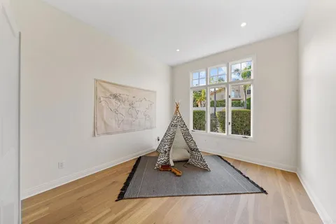 a view of a room with furniture wooden floor and windows