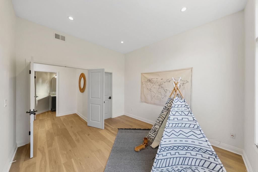 1838 Samoa Way Oceanside, CA 92054 - Photo 12 of 40 a view of a bedroom with wooden floor and windows