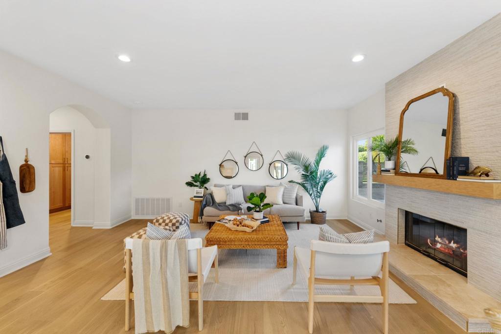 1838 Samoa Way Oceanside, CA 92054 - Photo 15 of 40 a living room with furniture a fireplace and a potted plant