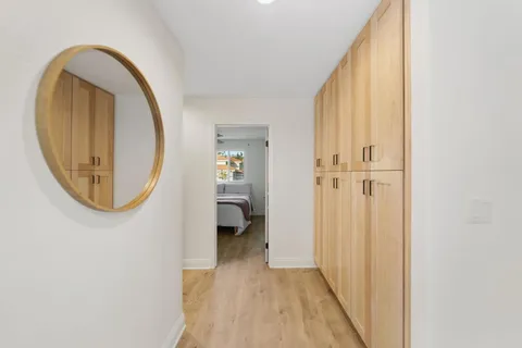 a view of a livingroom with wooden floor and a staircase