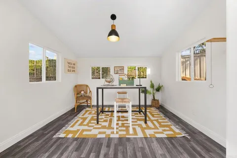 a living room with a rug and a table