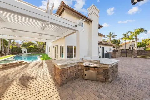 a view of a patio with couches table and chairs and potted plants