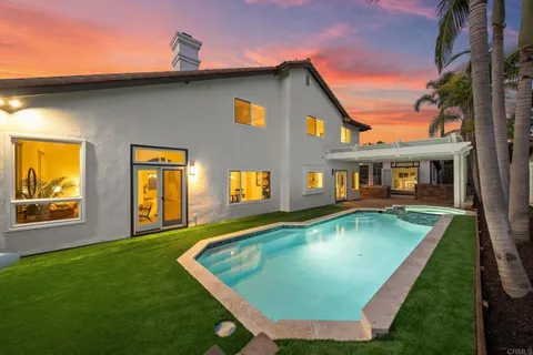 a view of a house with swimming pool in front of it