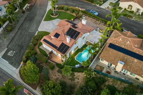 an aerial view of a house with a yard