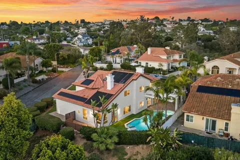 an aerial view of multiple houses with a yard