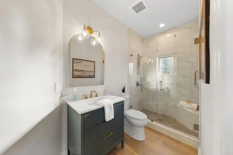 a bathroom with a toilet sink and shower