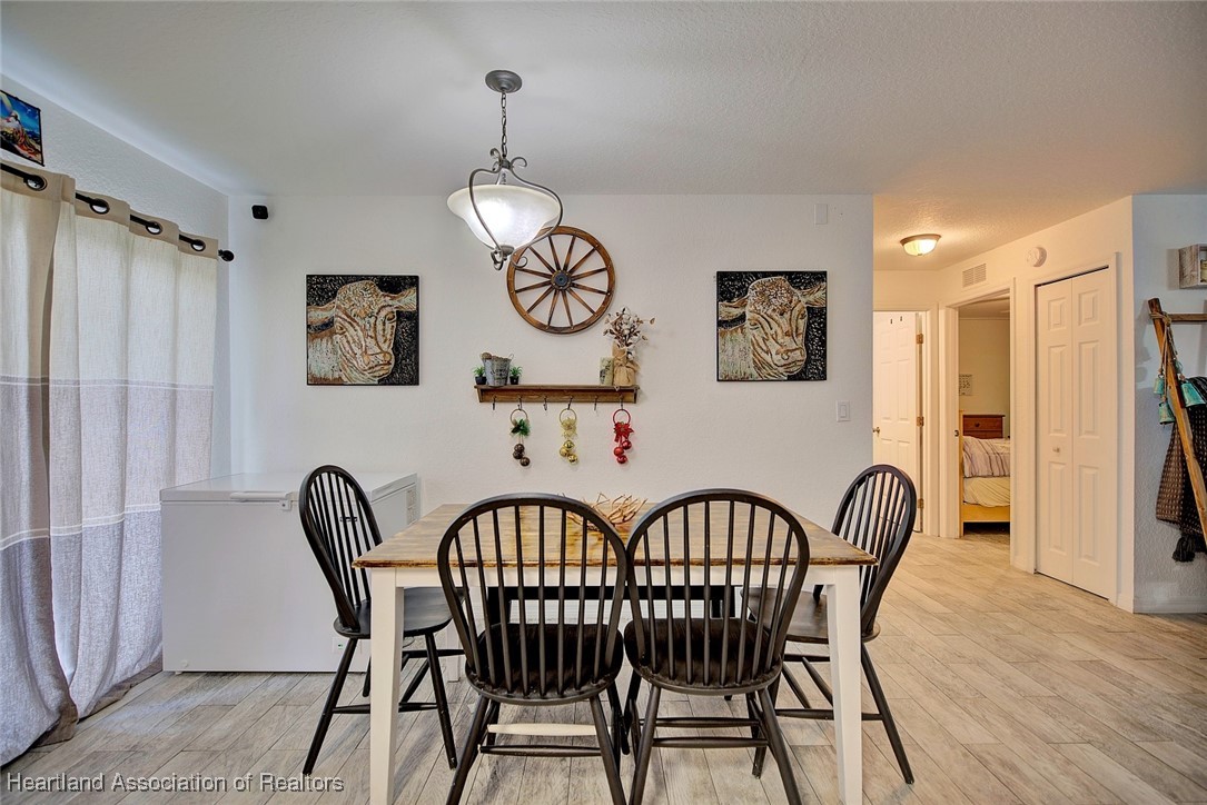 1700 Schlosser Road Sebring, FL 33870 - Photo 11 of 40 a view of a dining room with furniture and wooden floor