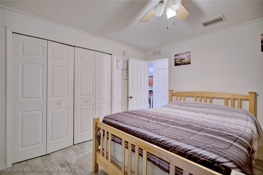 1700 Schlosser Road Sebring, FL 33870 - Photo 19 of 40 a bedroom with a bed and a chandelier
