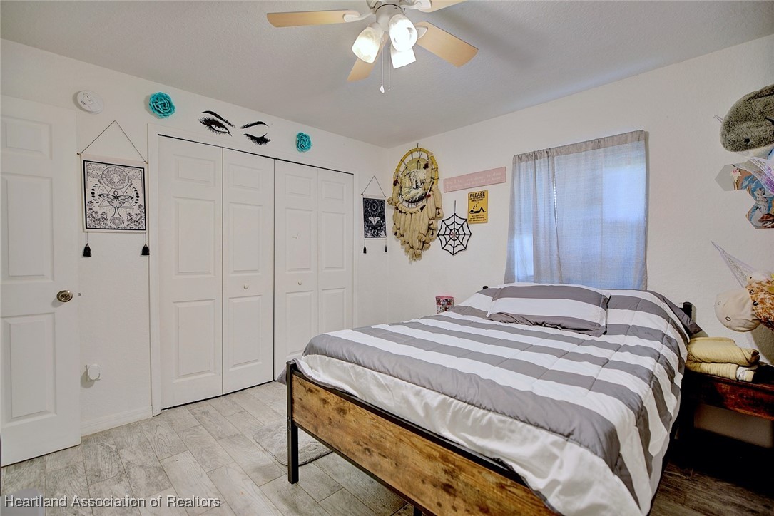 1700 Schlosser Road Sebring, FL 33870 - Photo 22 of 40 a bedroom with a bed and a chandelier