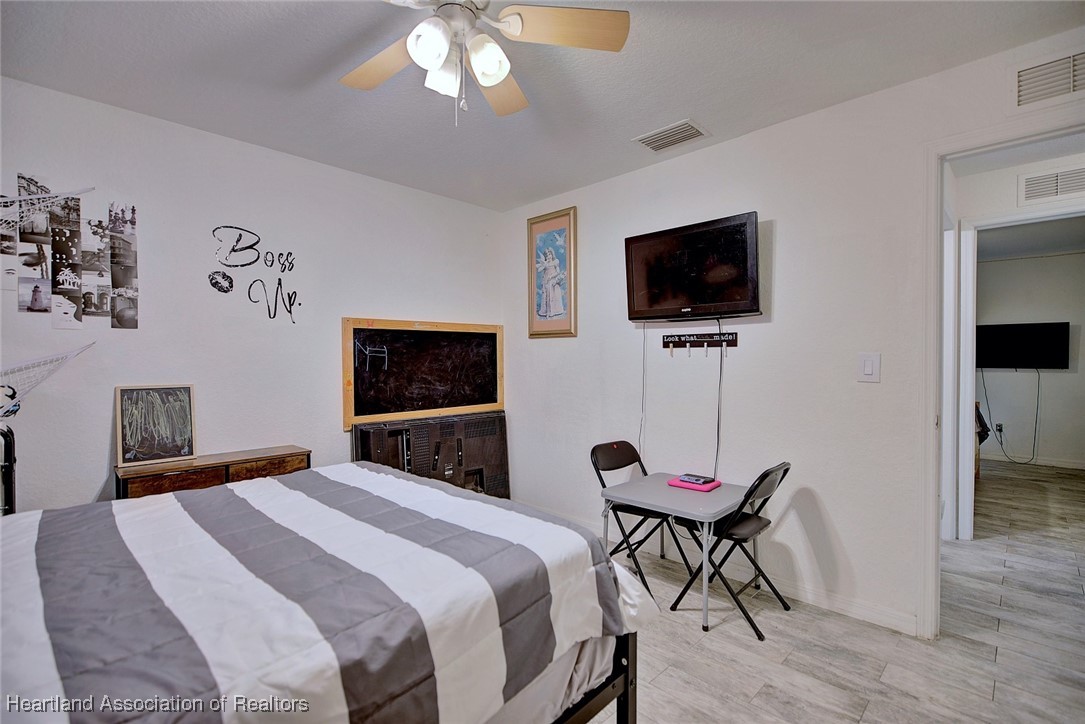 1700 Schlosser Road Sebring, FL 33870 - Photo 23 of 40 a bedroom with a bed and a flat screen tv