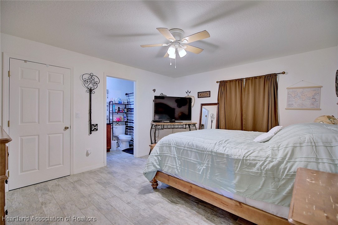 1700 Schlosser Road Sebring, FL 33870 - Photo 24 of 40 a bedroom with a bed and a flat screen tv