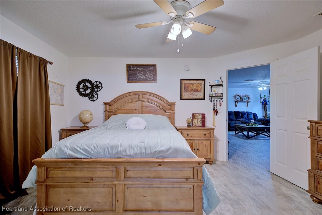 1700 Schlosser Road Sebring, FL 33870 - Photo 26 of 40 a bedroom with a bed and wooden floor