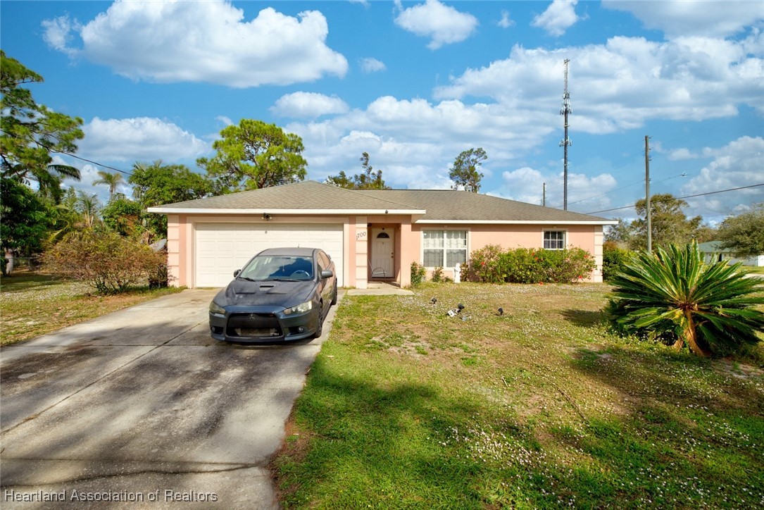 1700 Schlosser Road Sebring, FL 33870 - Photo 3 of 40 a car parked in front of a house