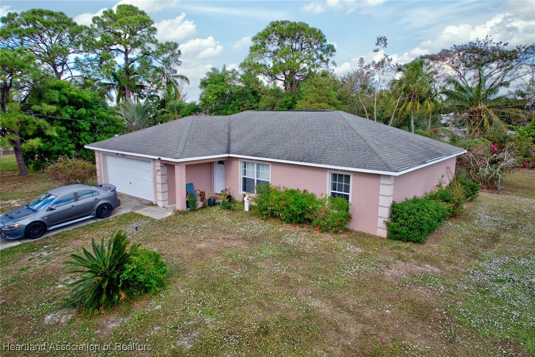 1700 Schlosser Road Sebring, FL 33870 - Photo 32 of 40 a aerial view of a house next to a yard and large trees