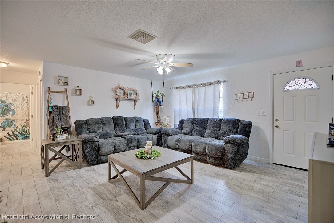 1700 Schlosser Road Sebring, FL 33870 - Photo 6 of 40 a living room with furniture and wooden floor