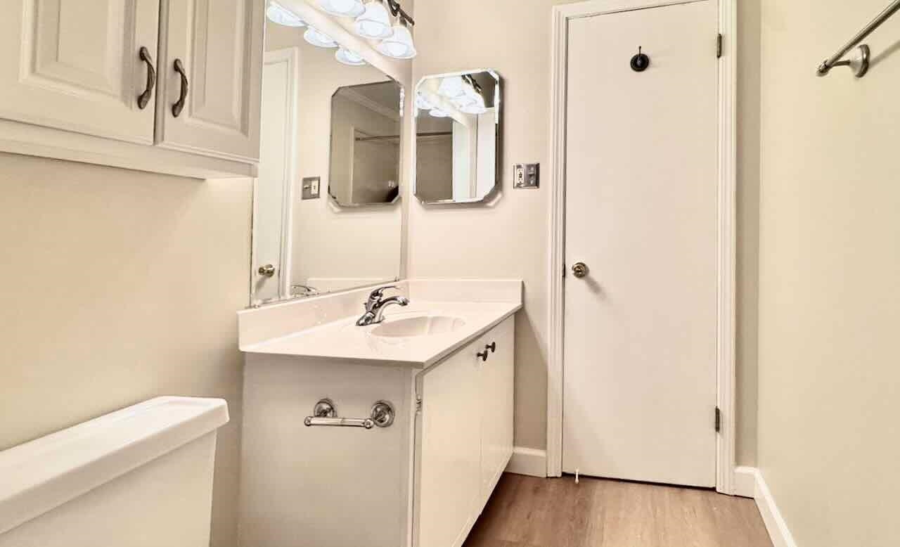 5718 Quince Road, Unit 10 Memphis, TN 38119 - Photo 16 of 28 Half bathroom with vanity and light wood-style flooring