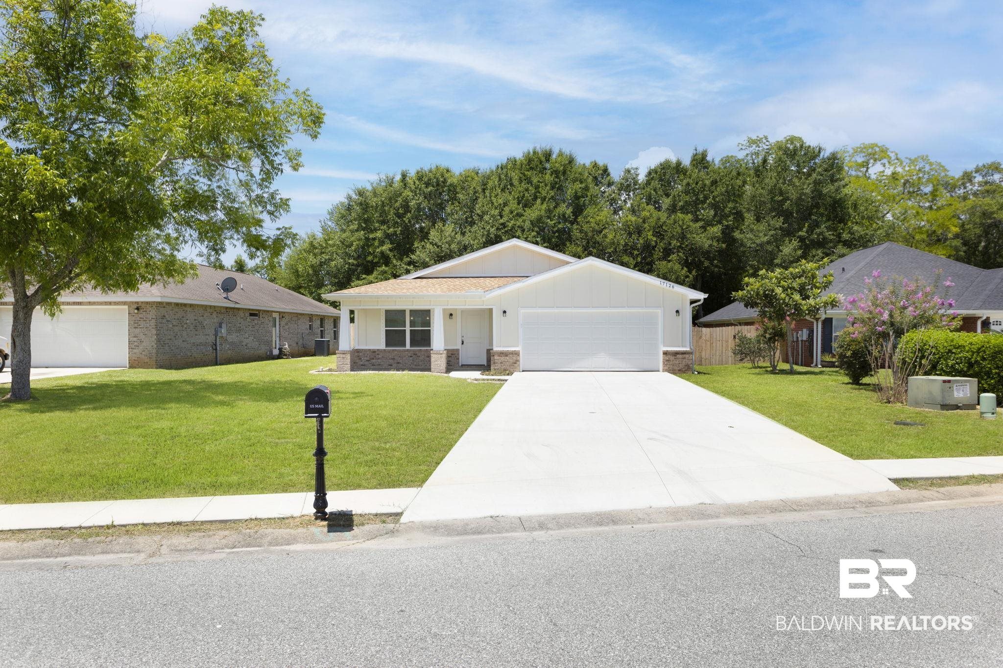 17126 Sugar Loop Foley, AL 36535 - Photo 28 of 28 Ranch-style home featuring an attached garage, concrete driveway, board and batten siding, and brick siding