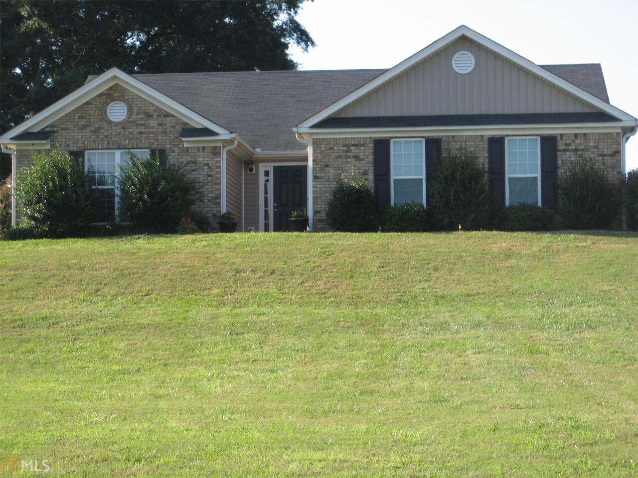 293 Middle Fork Lane, Unit 27 Carnesville, GA 30521 - Photo 1 of 1 a front view of a house with yard