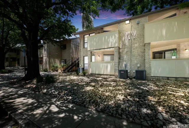 a backyard of a house with large trees