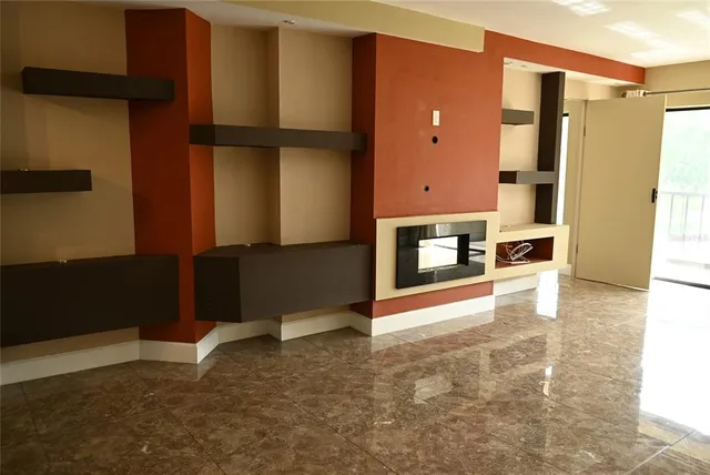 a view of a livingroom with furniture and an empty room