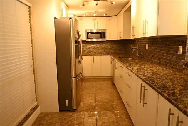 a view of a kitchen with wooden floor