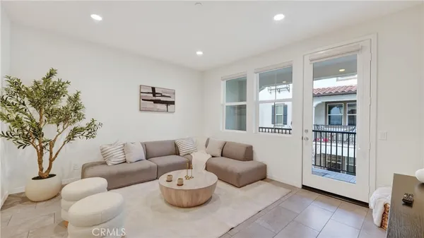a living room with furniture and a potted plant