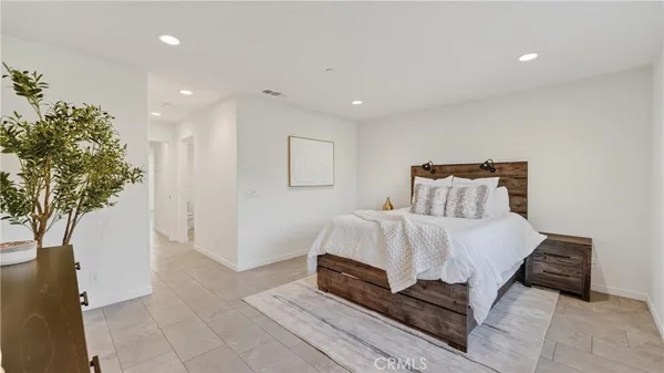 a bedroom with a bed and a plant