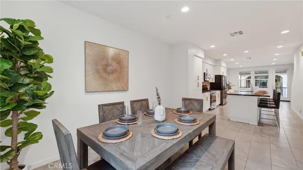 a dining room with furniture and wooden floor