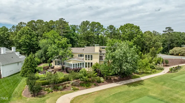 aerial view of a house with a yard and potted plants