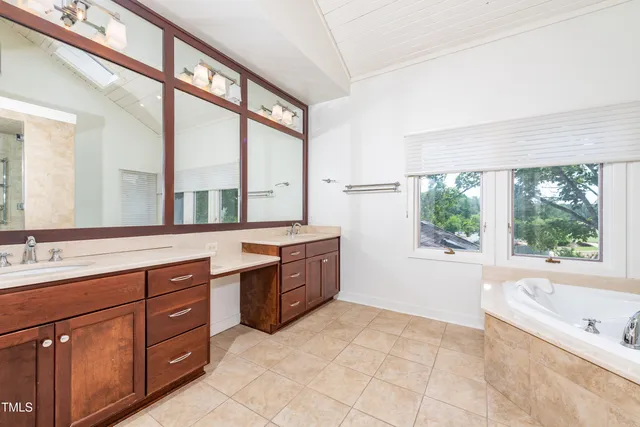 a bathroom with a bathtub sink and shower
