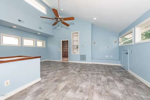 a bathroom with a bathtub shower sink vanity and toilet