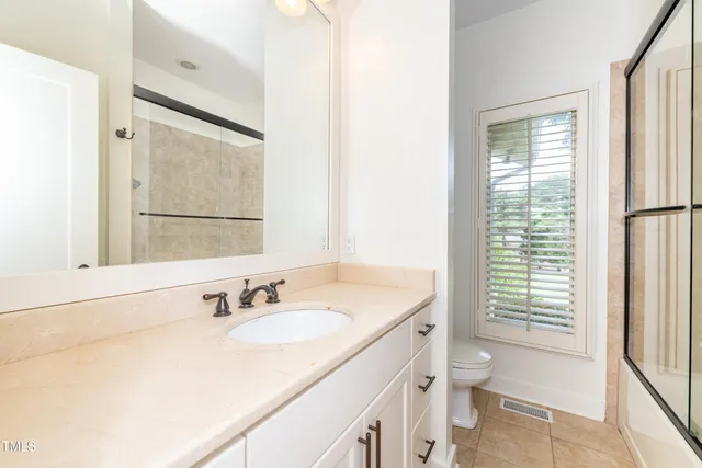 a view of a hallway with wooden floor and entryway