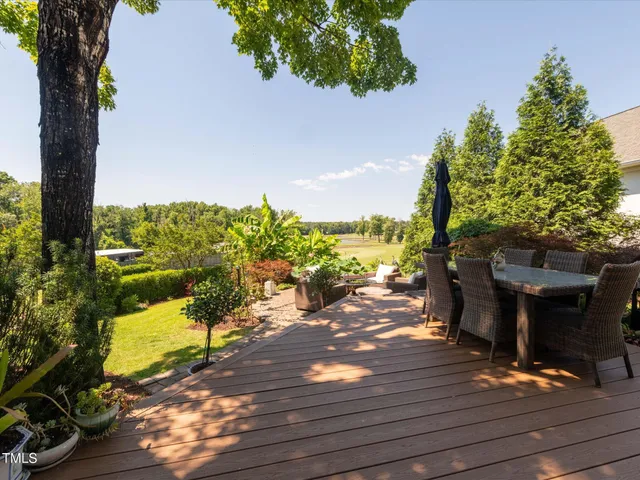 a view of a porch with a floor to ceiling window next to a yard