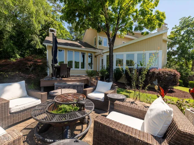 a view of a house with backyard sitting area and swimming pool