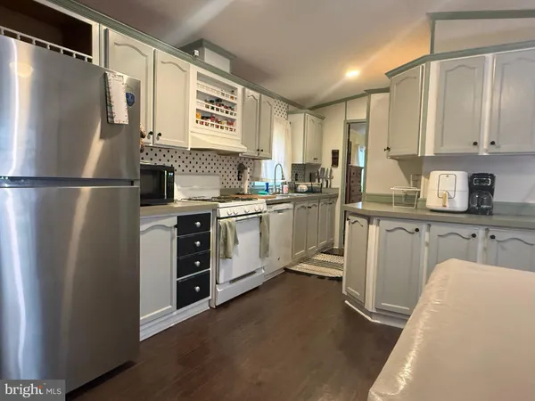 a kitchen with a stove and a refrigerator