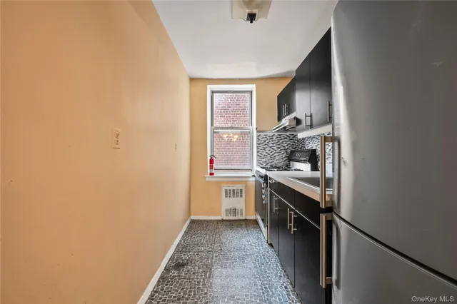a kitchen with a sink and stove top oven