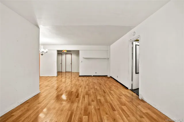 a view of an empty room and wooden floor