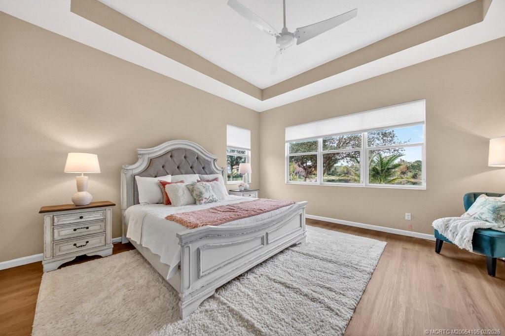 8121 Southwest Marin Drive Stuart, FL 34997 - Photo 16 of 31 a bedroom with a large bed and a window