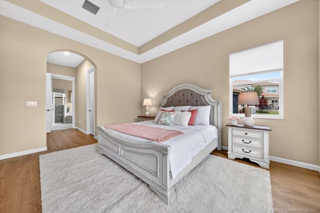 8121 Southwest Marin Drive Stuart, FL 34997 - Photo 17 of 31 a bedroom with a bed and a dresser