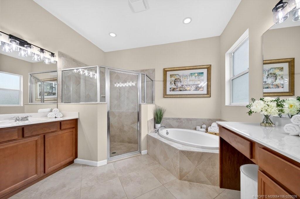 8121 Southwest Marin Drive Stuart, FL 34997 - Photo 18 of 31 a bathroom with a tub a sink and mirror