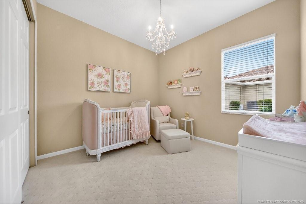 8121 Southwest Marin Drive Stuart, FL 34997 - Photo 22 of 31 a bedroom with a bed and a window