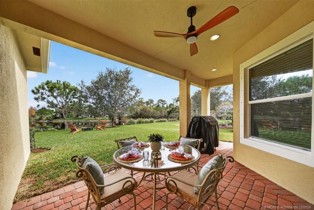 8121 Southwest Marin Drive Stuart, FL 34997 - Photo 25 of 31 a view of a patio with a table chairs and a table