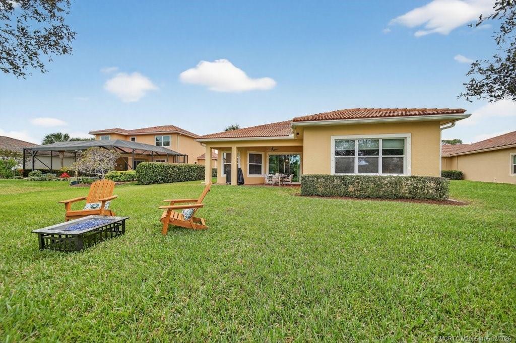 8121 Southwest Marin Drive Stuart, FL 34997 - Photo 27 of 31 a view of a house with a backyard porch and sitting area