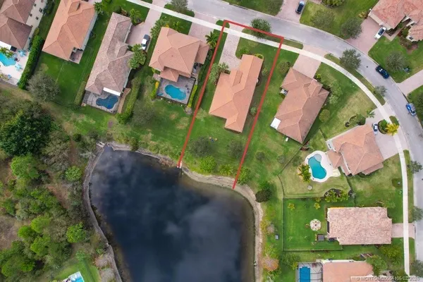 an aerial view of residential house with outdoor space and lake view