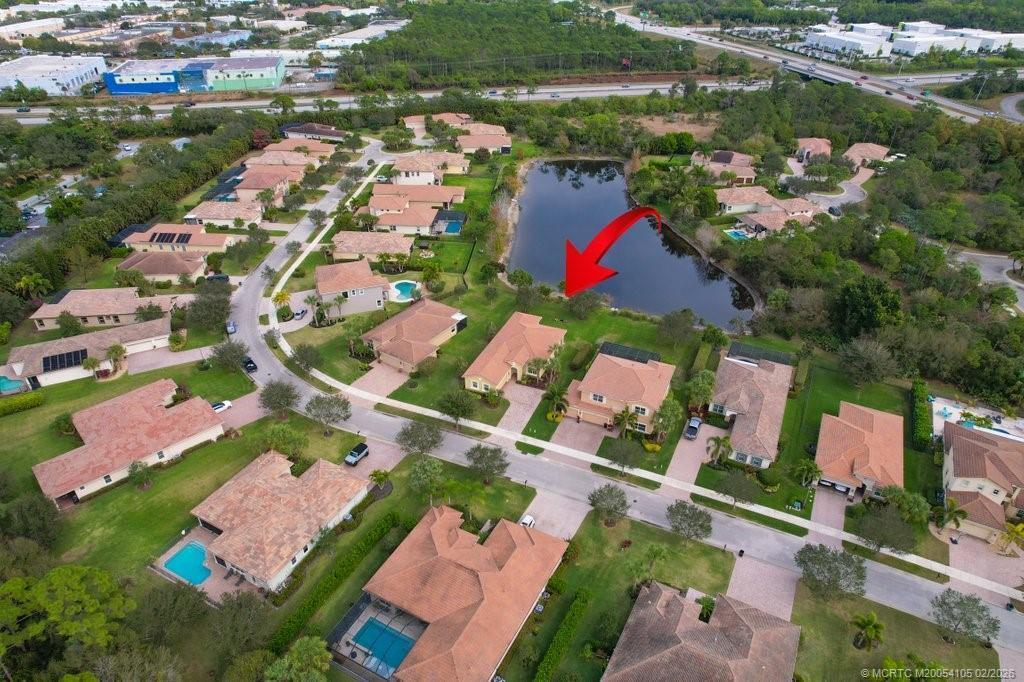 8121 Southwest Marin Drive Stuart, FL 34997 - Photo 30 of 31 an aerial view of residential house with outdoor space and lake view