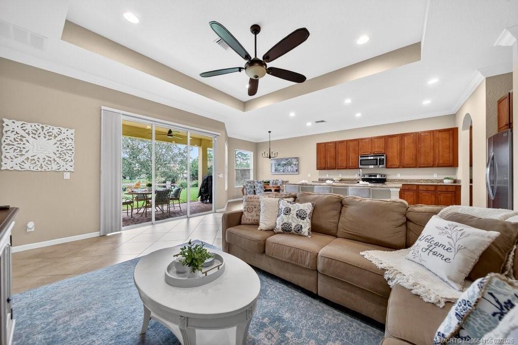 8121 Southwest Marin Drive Stuart, FL 34997 - Photo 9 of 31 a living room with furniture kitchen view and a large window