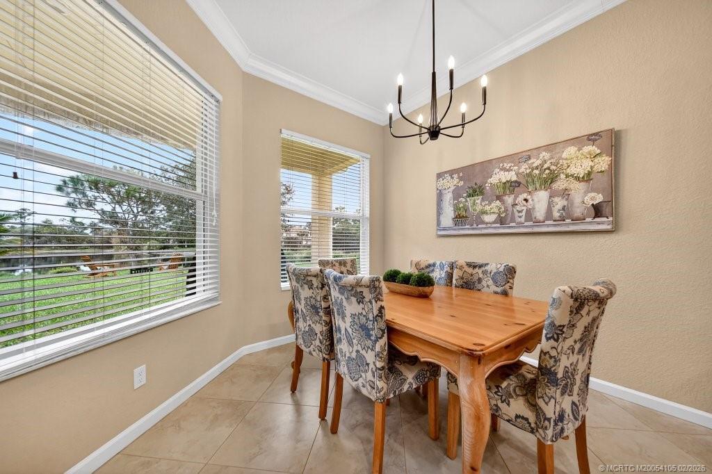 8121 Southwest Marin Drive Stuart, FL 34997 - Photo 10 of 31 a view of a dining room with furniture window and outside view