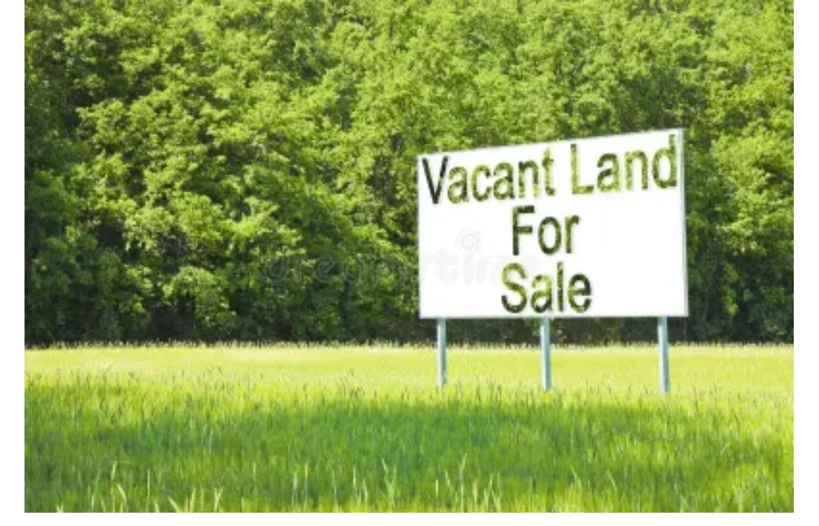 a sign that is sitting in the grass under an umbrella