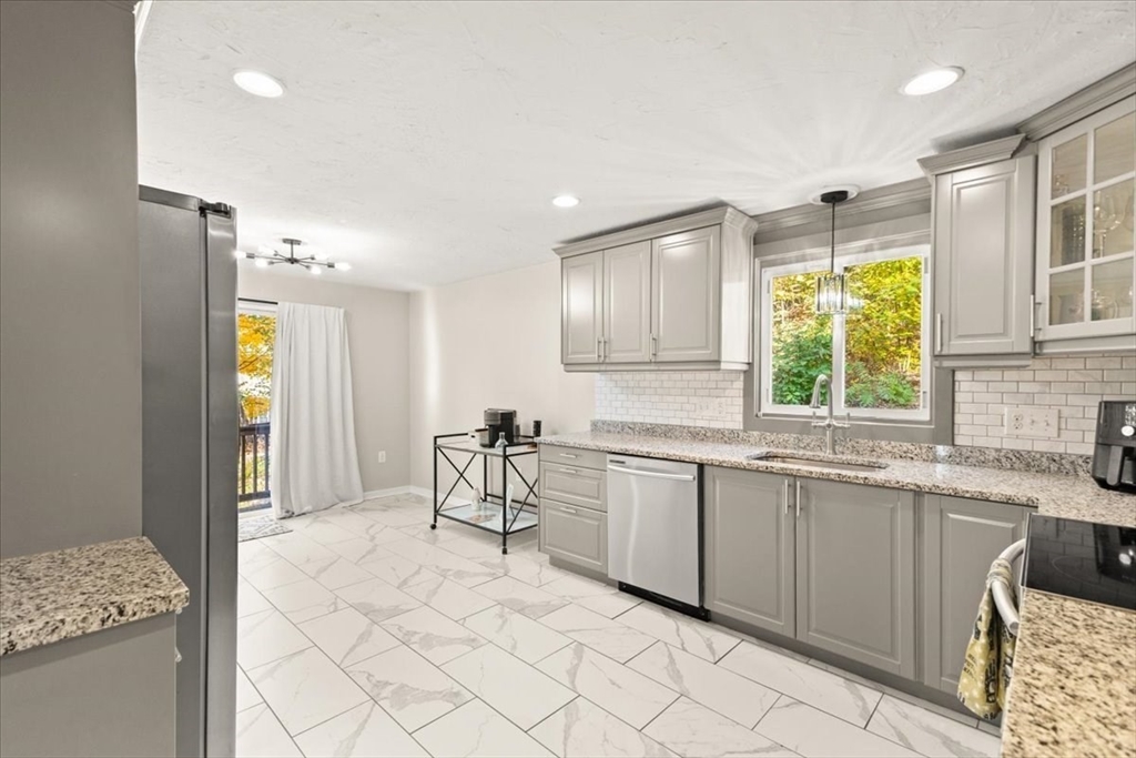 3 Federal Street, Unit 3 Blackstone, MA 01504 - Photo 11 of 27 a kitchen with a sink and chairs