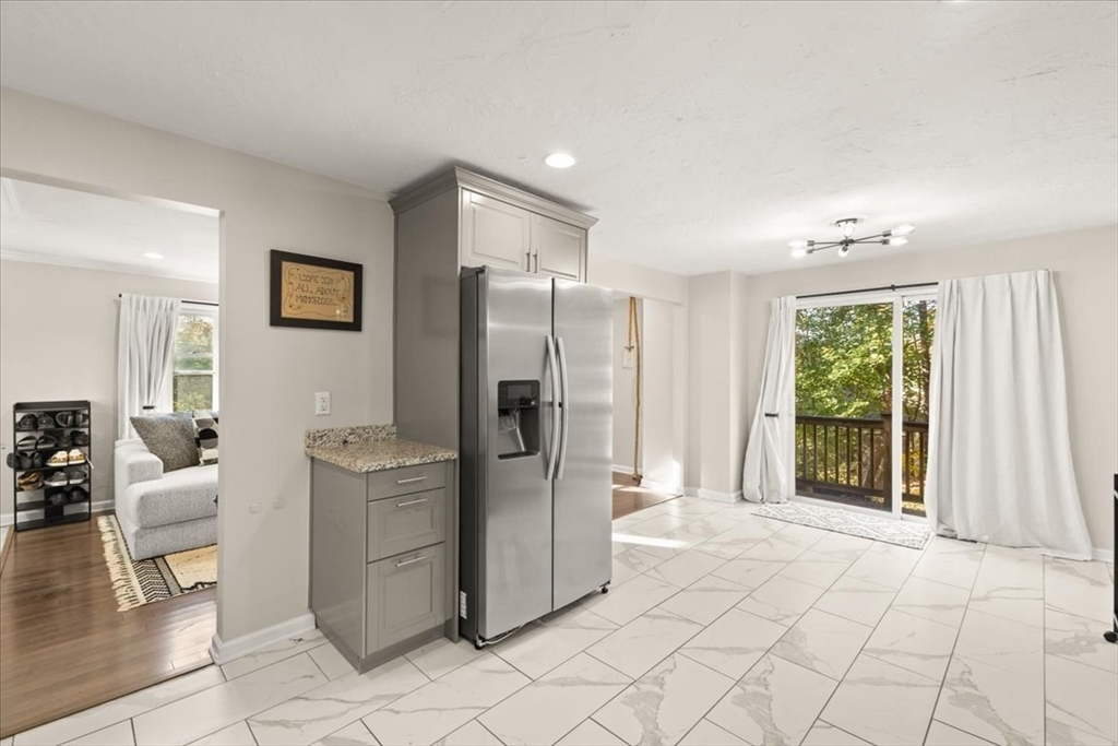 3 Federal Street, Unit 3 Blackstone, MA 01504 - Photo 12 of 27 a view of a kitchen with furniture and a refrigerator